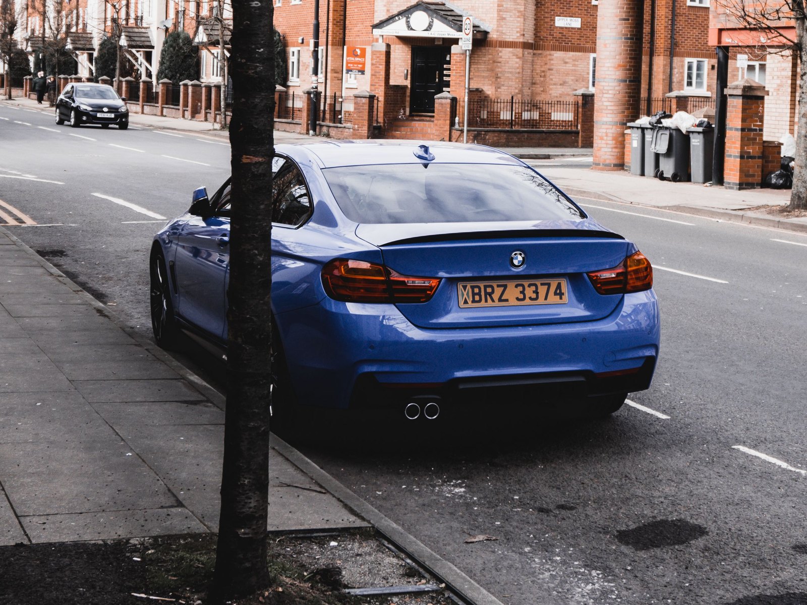 A car parked on a UK residential street with its number plate clearly visible